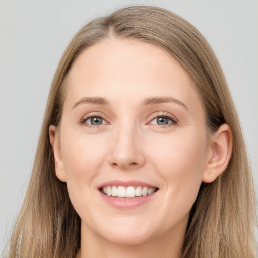 Joyful white young-adult female with long  brown hair and grey eyes