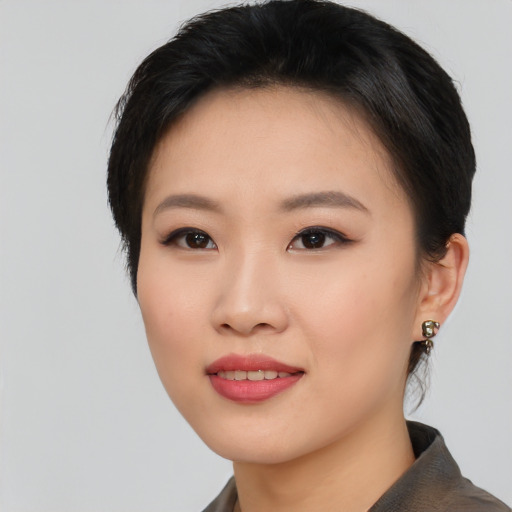 Joyful asian young-adult female with short  black hair and brown eyes