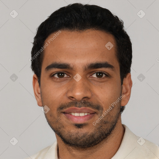 Joyful latino young-adult male with short  black hair and brown eyes