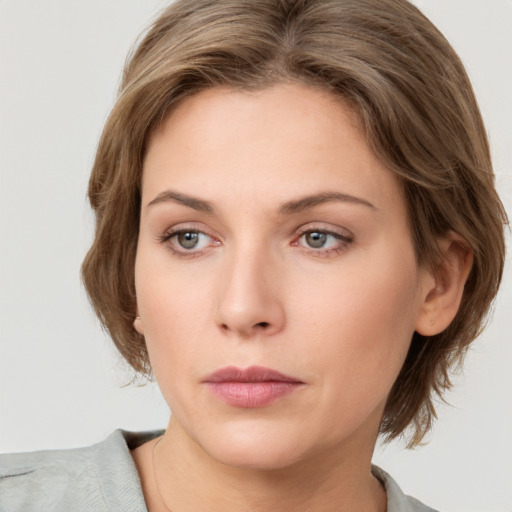 Neutral white young-adult female with medium  brown hair and grey eyes