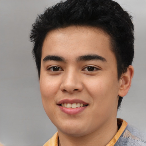 Joyful latino young-adult male with short  brown hair and brown eyes