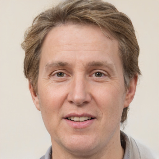 Joyful white adult male with short  brown hair and grey eyes