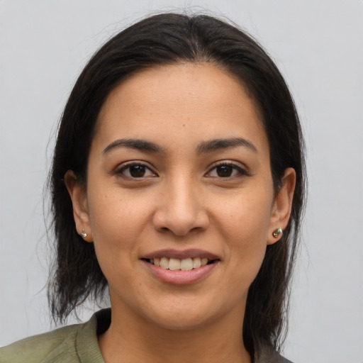 Joyful latino young-adult female with medium  brown hair and brown eyes