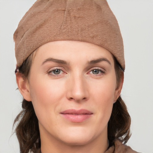 Joyful white young-adult female with medium  brown hair and grey eyes