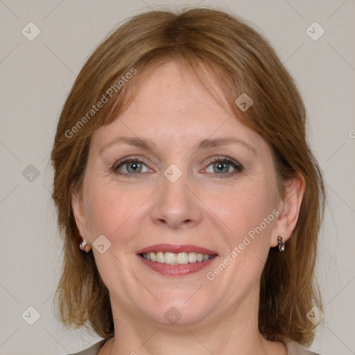 Joyful white adult female with medium  brown hair and blue eyes