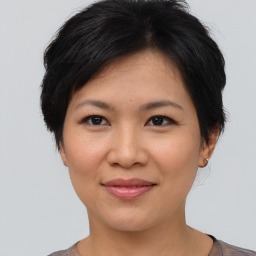 Joyful asian young-adult female with short  brown hair and brown eyes