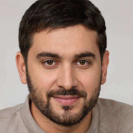 Joyful white young-adult male with short  brown hair and brown eyes