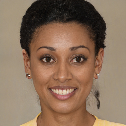 Joyful latino young-adult female with short  brown hair and brown eyes