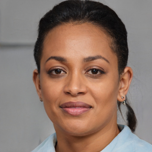 Joyful latino young-adult female with short  black hair and brown eyes