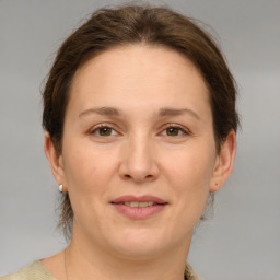 Joyful white adult female with medium  brown hair and brown eyes