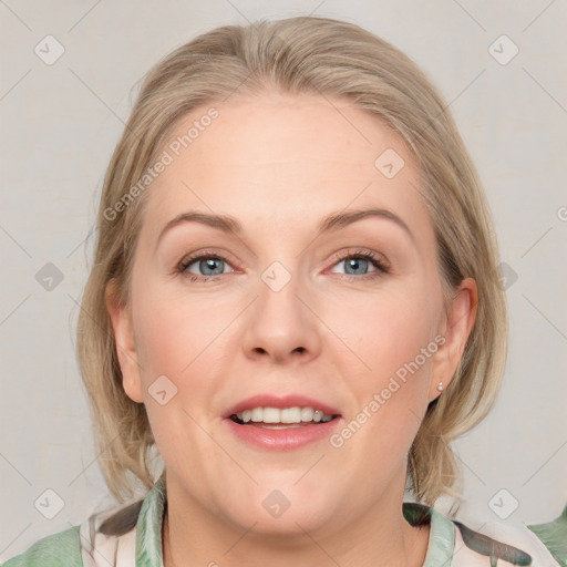 Joyful white adult female with medium  brown hair and blue eyes