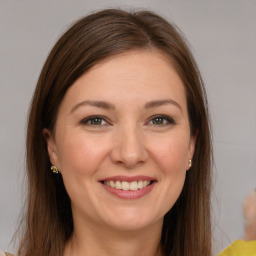 Joyful white young-adult female with medium  brown hair and brown eyes