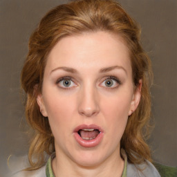 Joyful white young-adult female with medium  brown hair and green eyes