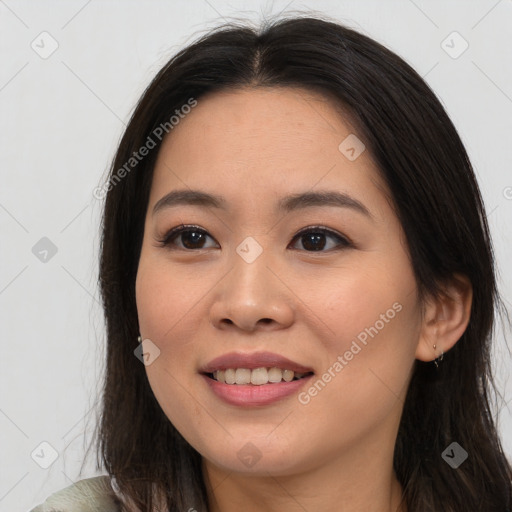 Joyful asian young-adult female with long  brown hair and brown eyes