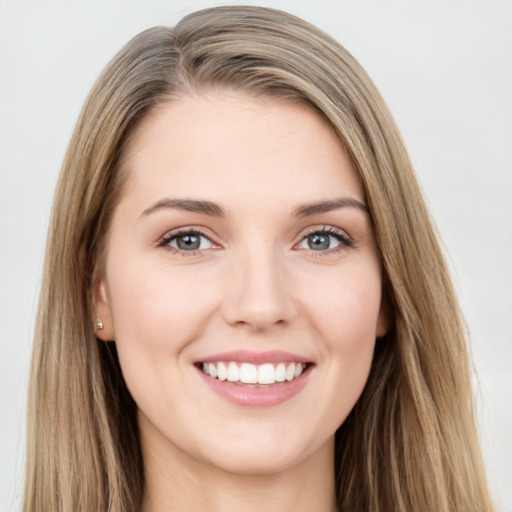 Joyful white young-adult female with long  brown hair and green eyes