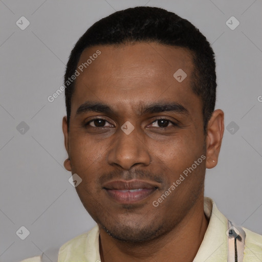 Joyful black young-adult male with short  black hair and brown eyes