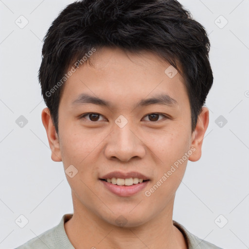 Joyful asian young-adult male with short  brown hair and brown eyes