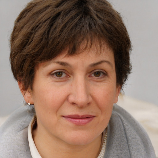 Joyful white adult female with short  brown hair and brown eyes