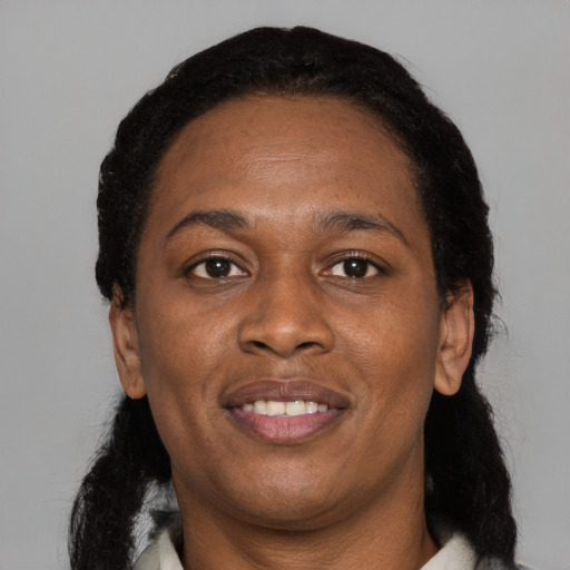 Joyful black adult female with medium  black hair and brown eyes