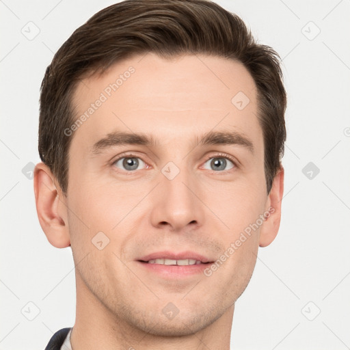 Joyful white young-adult male with short  brown hair and grey eyes