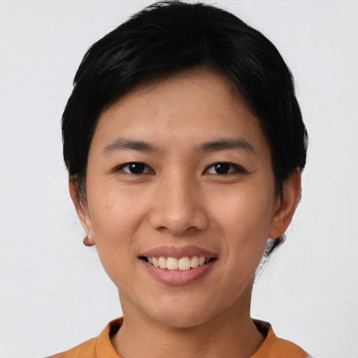 Joyful asian young-adult female with short  black hair and brown eyes