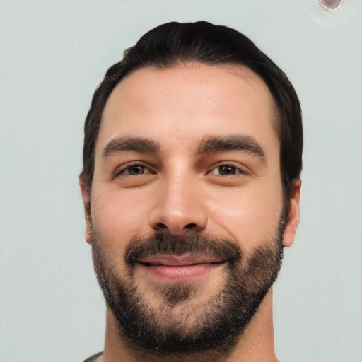 Joyful white young-adult male with short  black hair and brown eyes