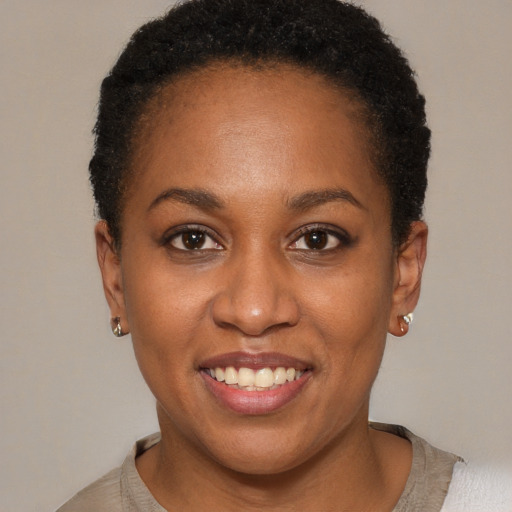 Joyful black young-adult female with short  brown hair and brown eyes