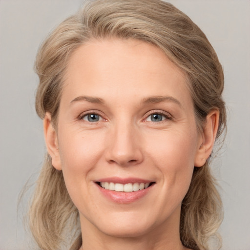 Joyful white young-adult female with medium  brown hair and blue eyes