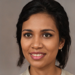 Joyful black young-adult female with medium  brown hair and brown eyes