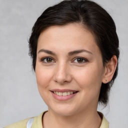 Joyful white young-adult female with medium  brown hair and brown eyes