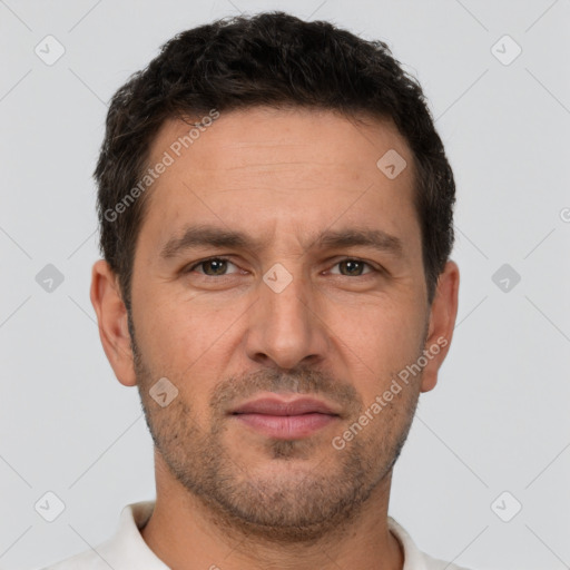 Joyful white adult male with short  brown hair and brown eyes