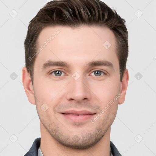 Joyful white young-adult male with short  brown hair and grey eyes