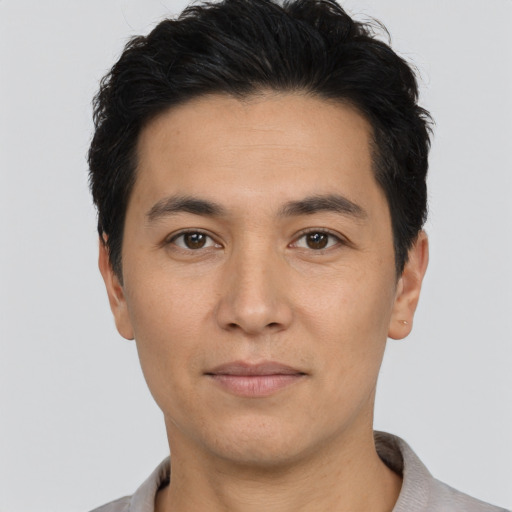 Joyful asian young-adult male with short  black hair and brown eyes