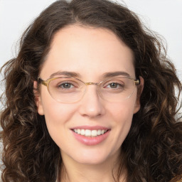 Joyful white adult female with long  brown hair and brown eyes