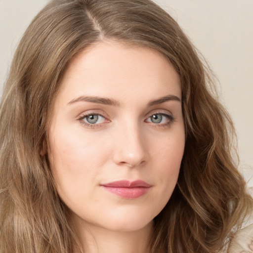 Joyful white young-adult female with long  brown hair and green eyes