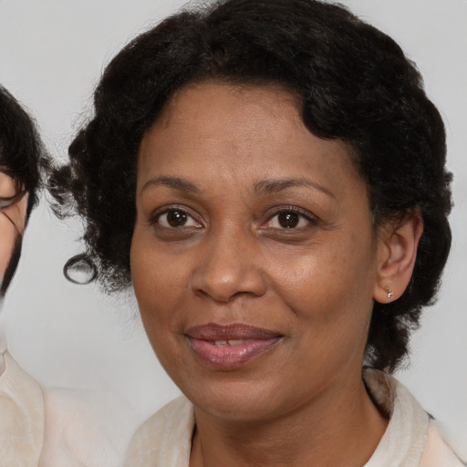 Joyful latino adult female with medium  brown hair and brown eyes