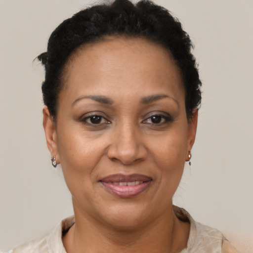 Joyful latino adult female with short  black hair and brown eyes