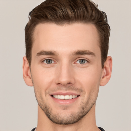 Joyful white young-adult male with short  brown hair and grey eyes