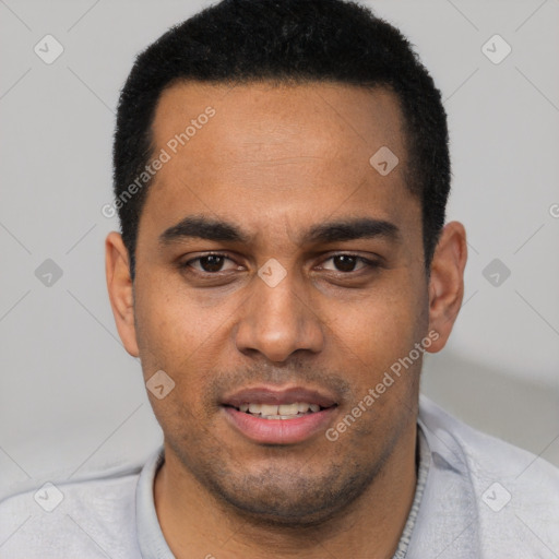 Joyful white young-adult male with short  black hair and brown eyes