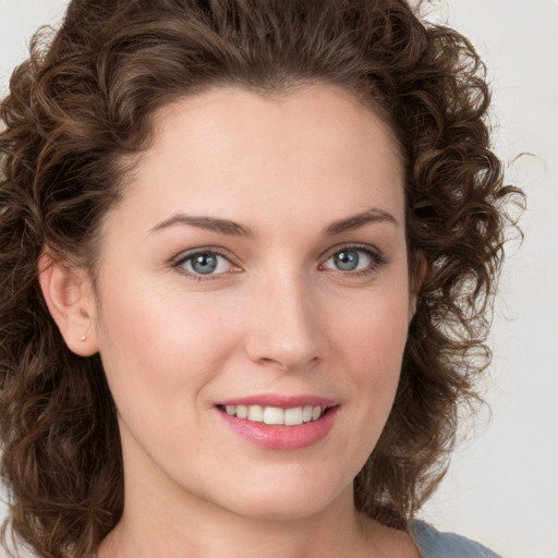 Joyful white young-adult female with medium  brown hair and green eyes