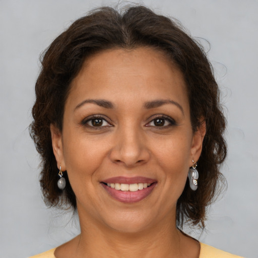 Joyful white adult female with medium  brown hair and brown eyes