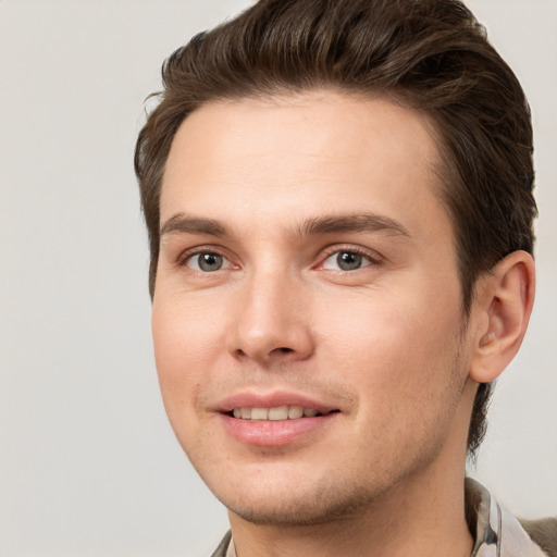 Joyful white young-adult male with short  brown hair and brown eyes