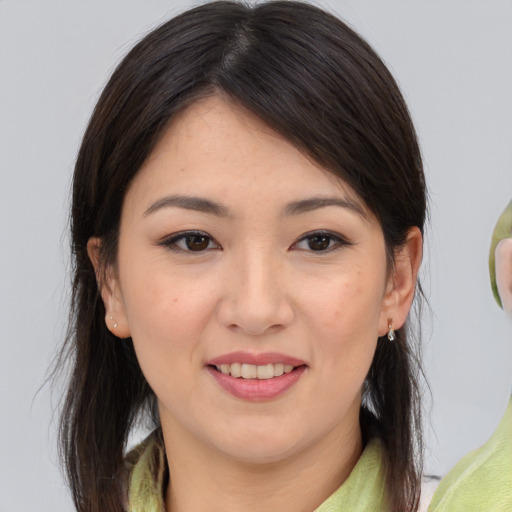 Joyful asian young-adult female with medium  brown hair and brown eyes