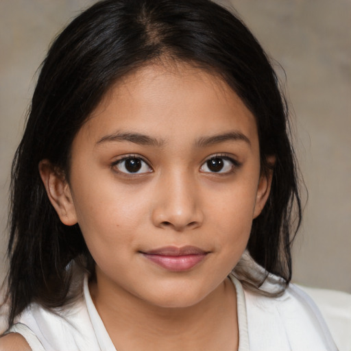 Joyful latino child female with medium  brown hair and brown eyes