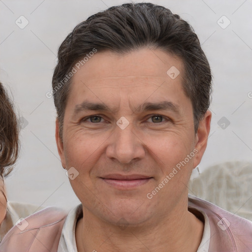 Joyful white adult male with short  brown hair and brown eyes