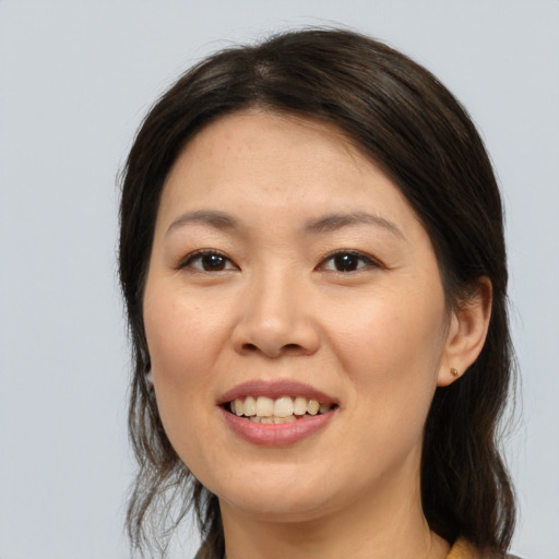 Joyful white young-adult female with medium  brown hair and brown eyes