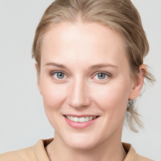 Joyful white young-adult female with medium  brown hair and blue eyes