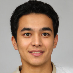 Joyful latino young-adult male with short  brown hair and brown eyes