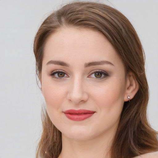 Joyful white young-adult female with medium  brown hair and green eyes