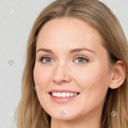 Joyful white young-adult female with long  brown hair and blue eyes